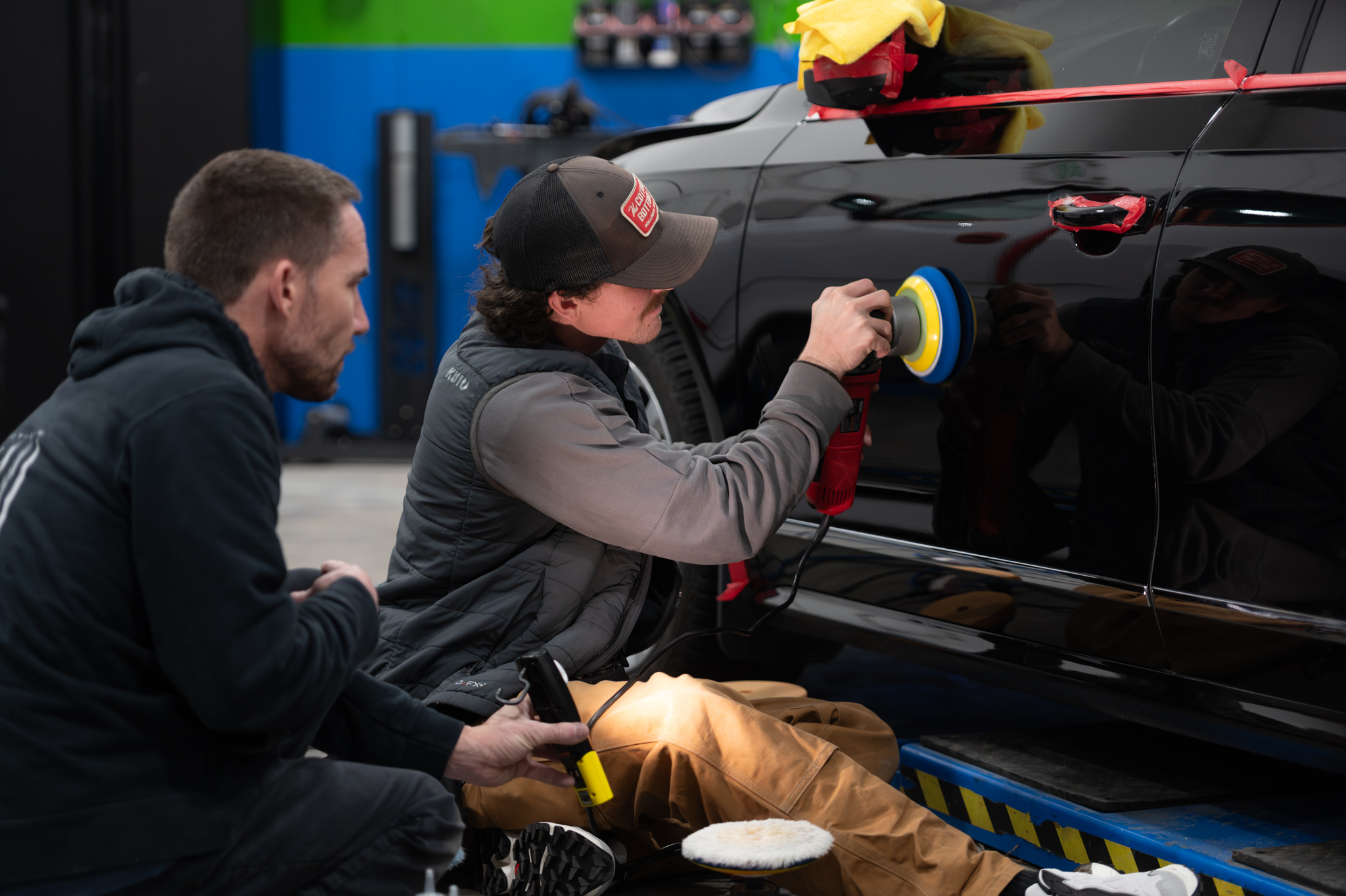 Jonathan Monson and Jason Killmer leading hands-on paint correction training in the bay